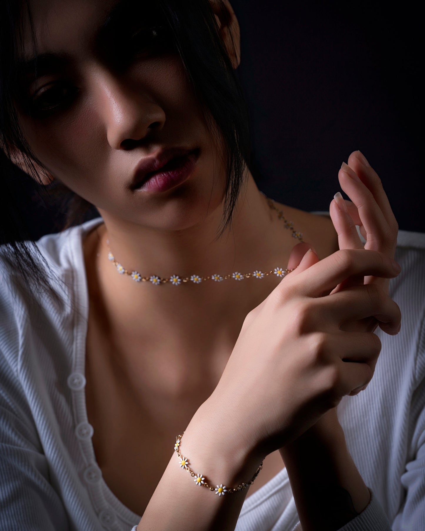 Model wearing the matching Sunward daisy necklace and bracelet set