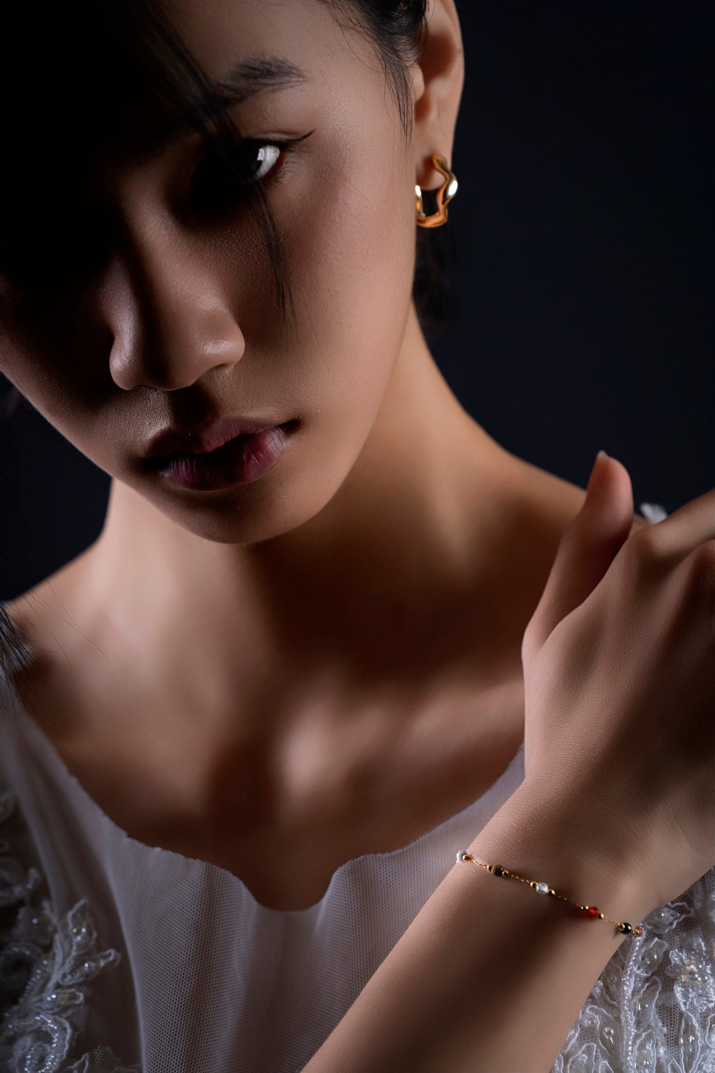 Model wearing the Meadow natural stone bracelet with Flux gold huggie earrings