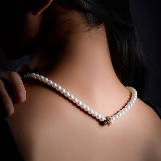 First Light pearl-look necklace worn at the neckline